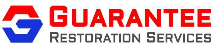 Guarantee Restoration Services logo on black background.