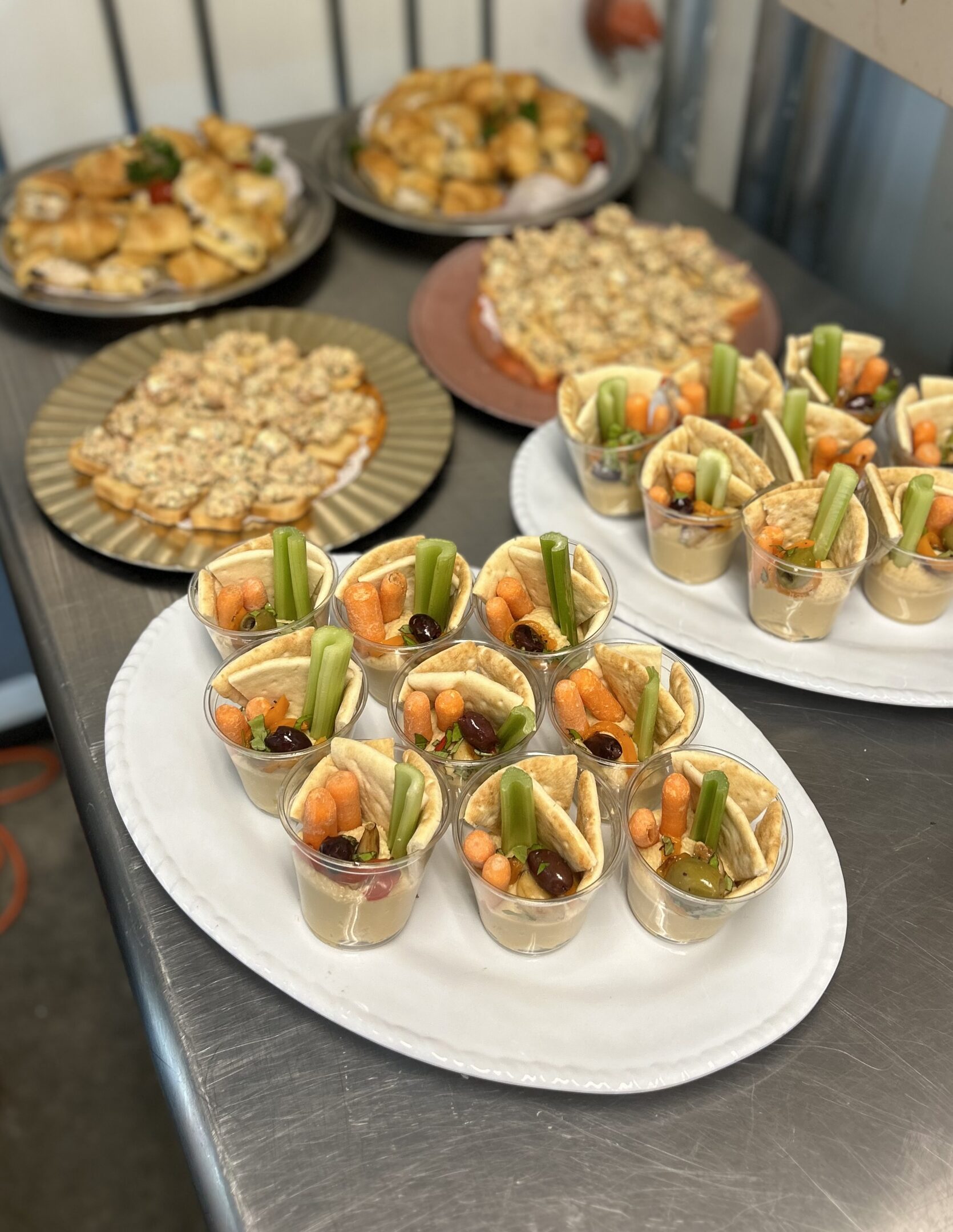 Appetizer cups with veggies, dip and crackers