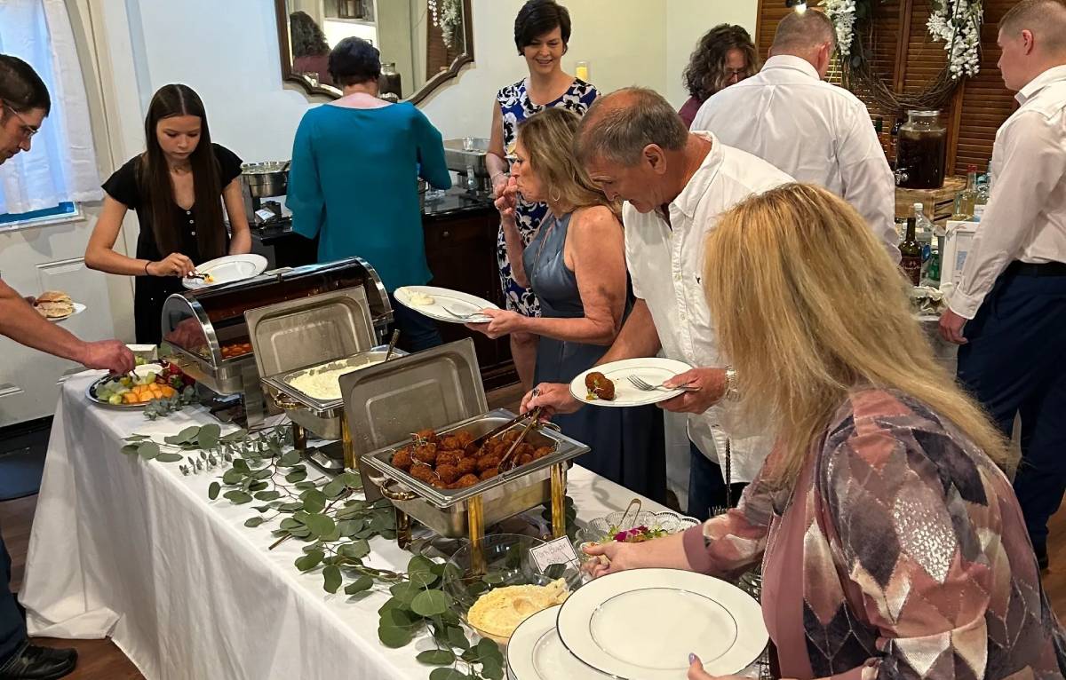 Guests serving themselves at buffet table