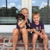 Girl taking photo, boy smiling on steps