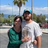 Couple embracing outdoors near palm trees