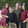 Smiling group portrait of five adults outdoors
