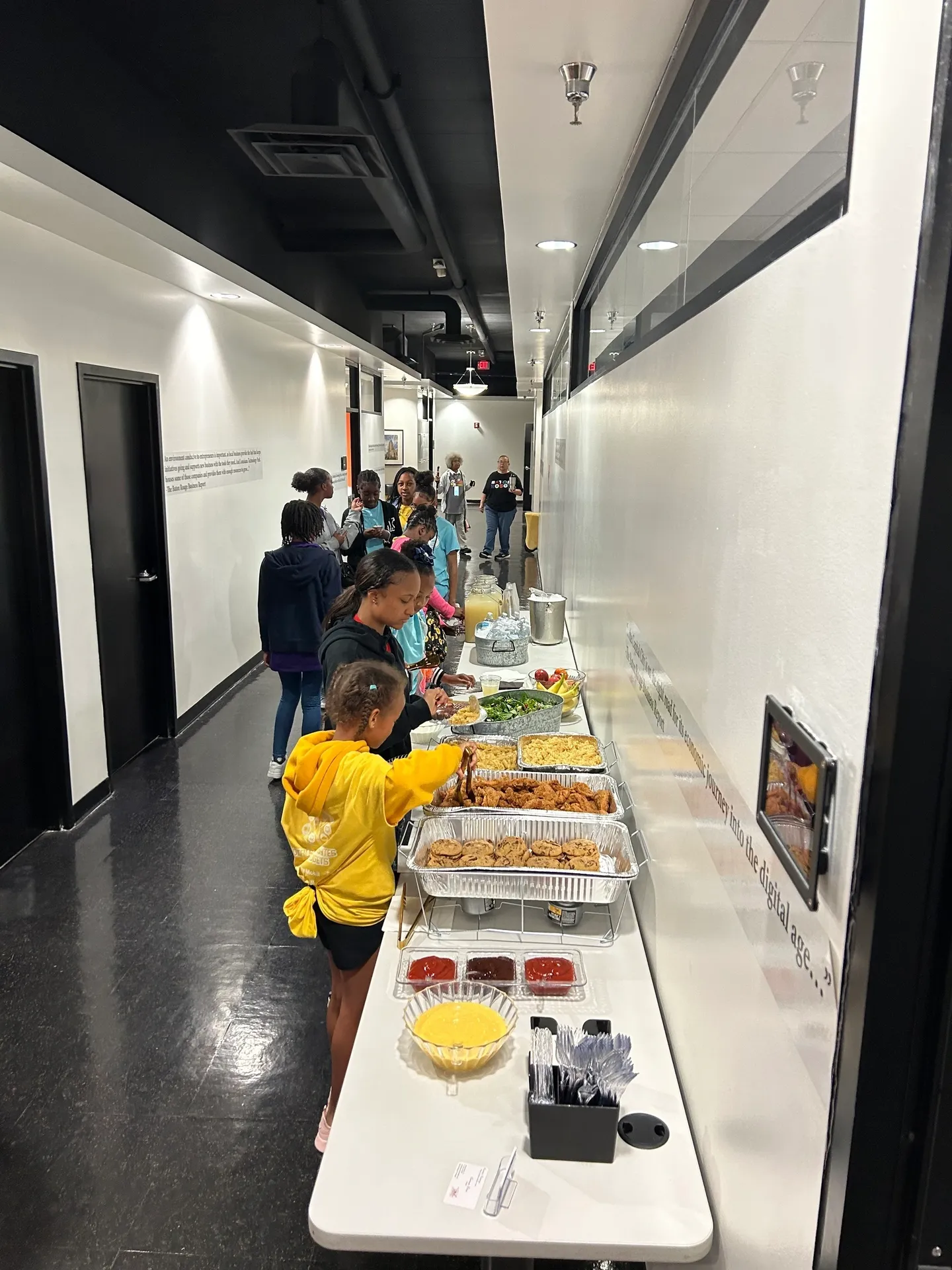 Kids in line at hallway buffet table
