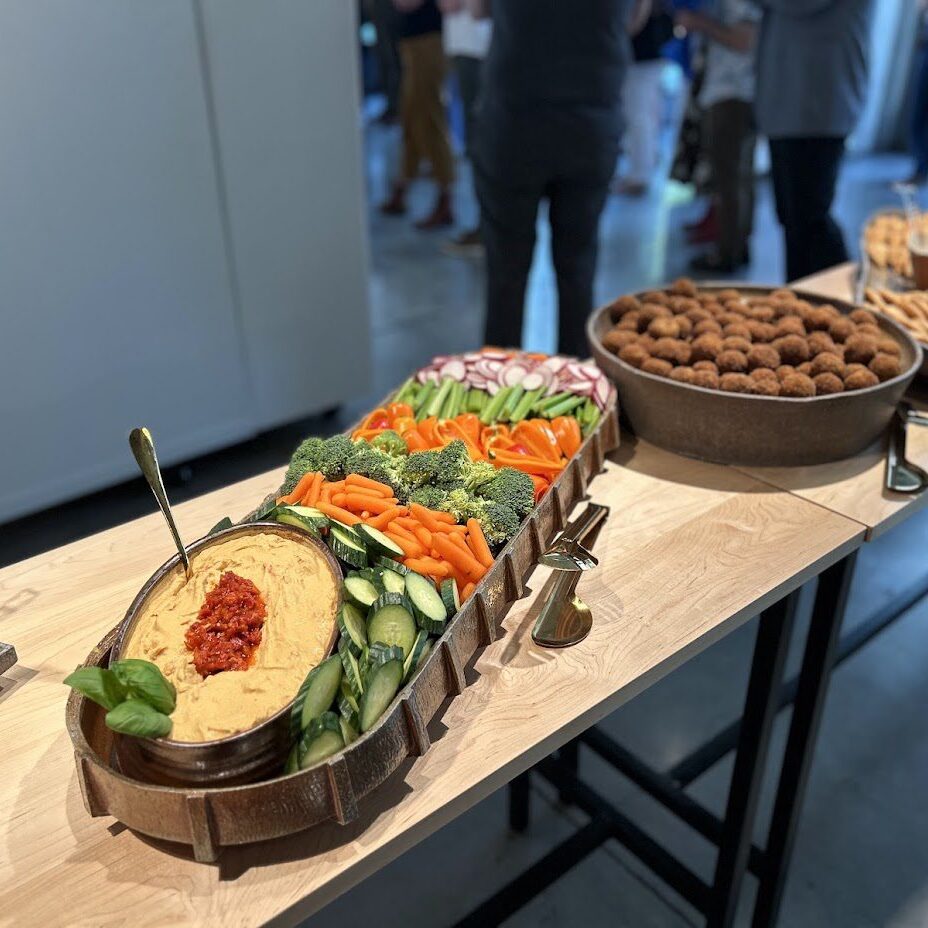 Buffet table with hummus, vegetables, falafel